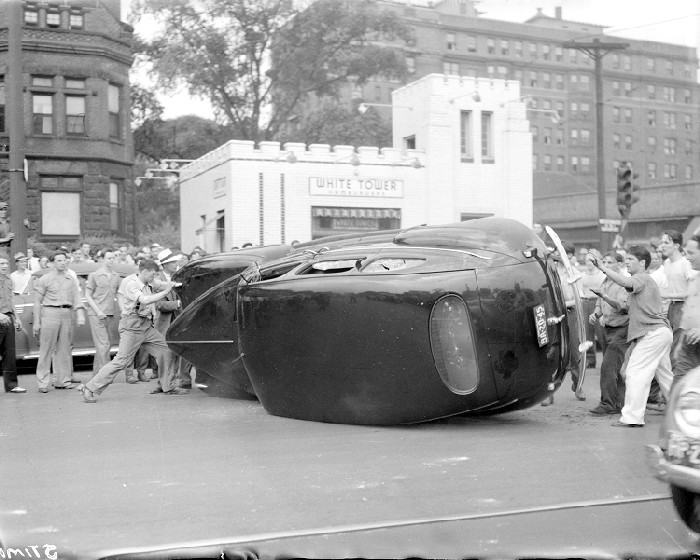 Riots: Detroit: Race Riots, 1943. June 21, 1943. Burning & Wrecked Autos. Rioters Running from Tear Gas. Burning Car on Woodward near Stimpson.