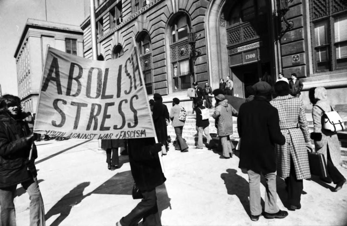 Protesters in Detroit holding a sign that reads, "Abolish S.T.R.E.S.S., Youth Against War & Fascism"